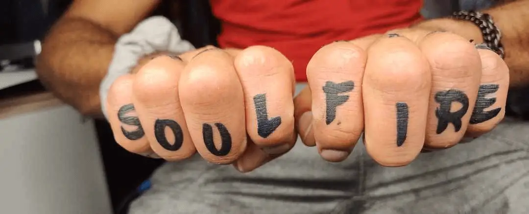 Tattoo: 'Soul Fire' text inked on knuckles