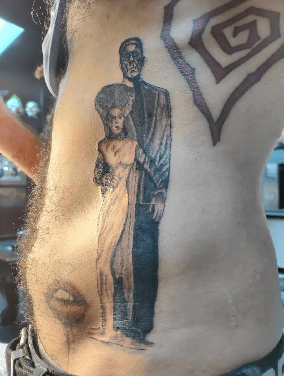 Artistic tattoo depicting a unique interpretation of Munster characters by Brianna Lyons