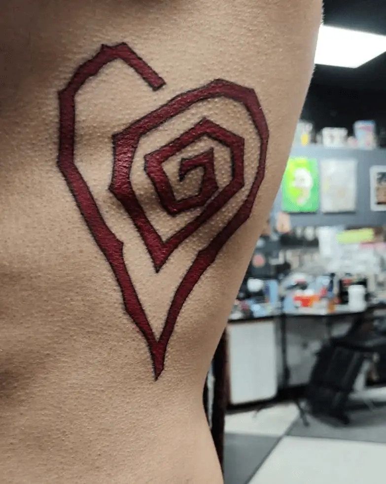 Tattoo featuring an artistic representation of a spiral shaped like a heart