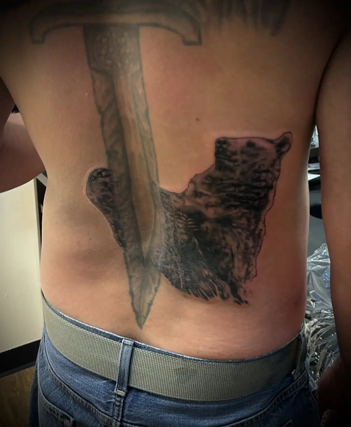 BL-ink Tattoo Colorado Springs back piece: black-grey bear profile intersected by a vertical sword