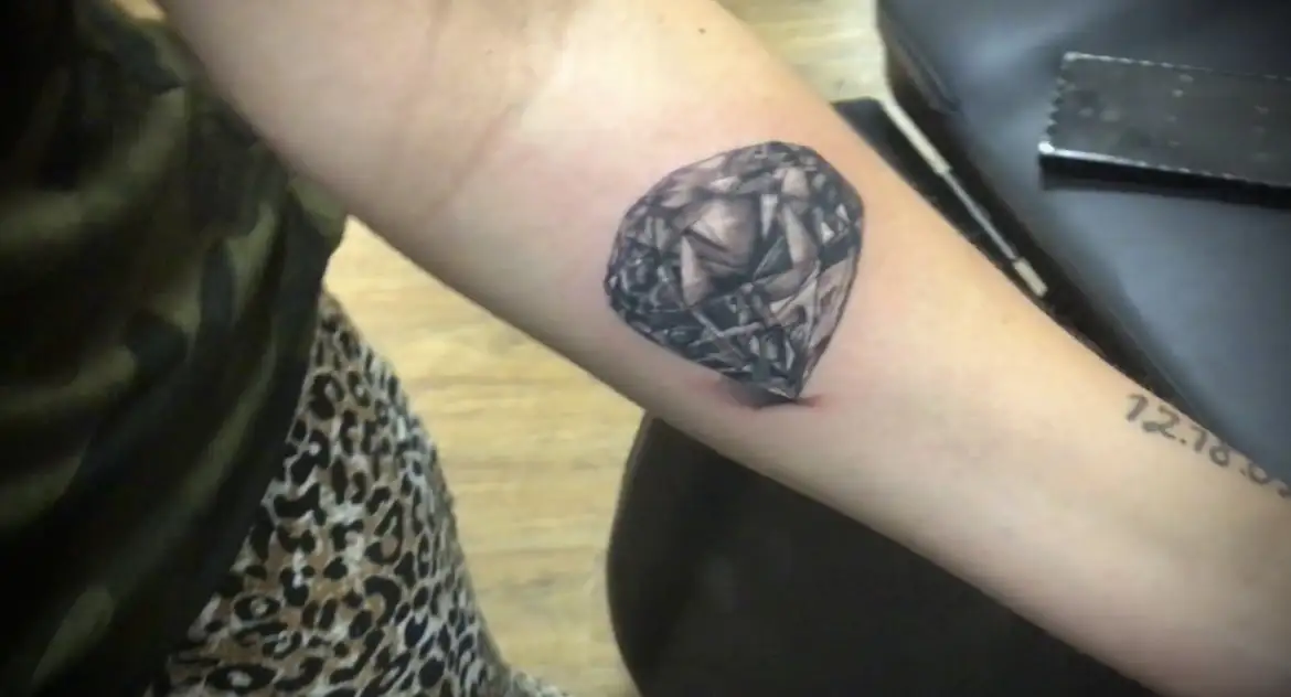 BL-ink Tattoo Colorado Springs inner-forearm piece: realistic faceted diamond in black-grey style