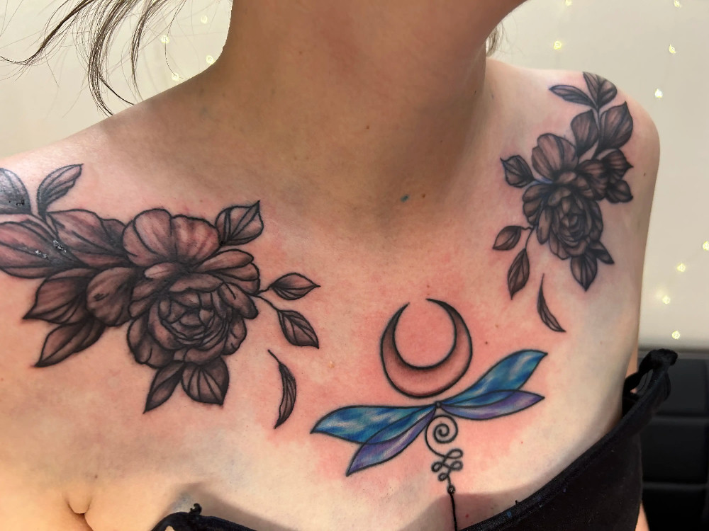 Dragonfly and floral chest tattoo by Bri Lyons at BL-INK Tattoo